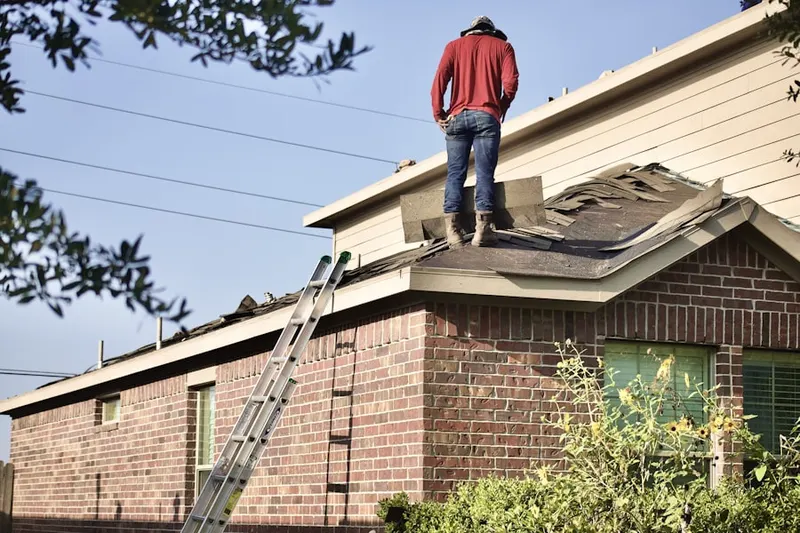 Professional roofer working on a residential roof in Severn